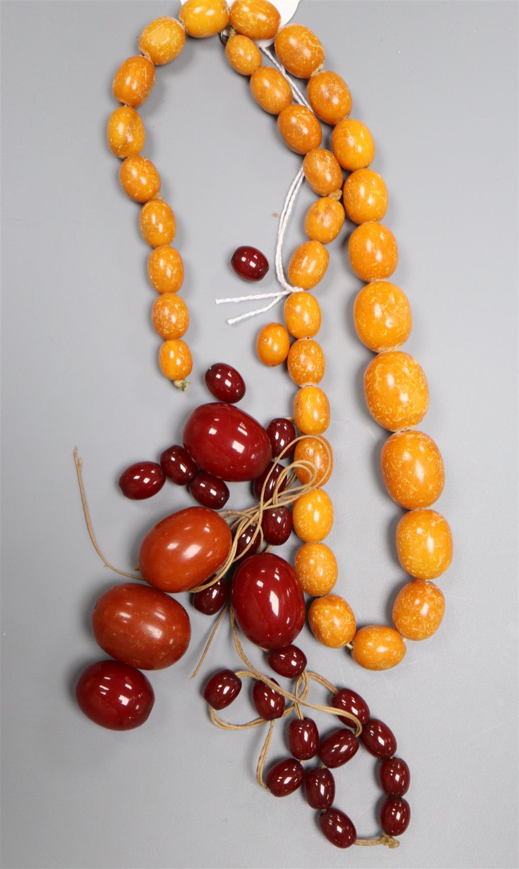 A single strand graduated amber bead necklace, 48cm, gross 40 grams, a large amber bead 10 grams and other loose beads